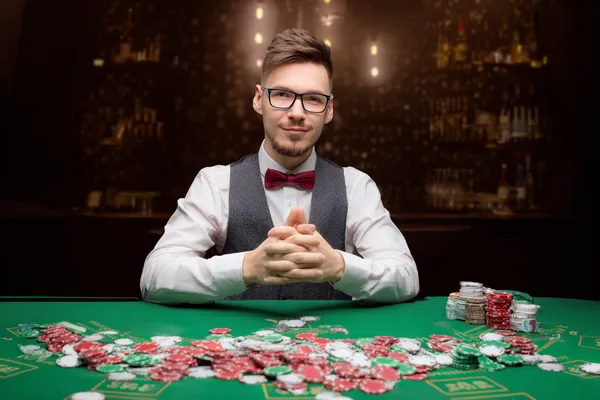 A confident dealer surrounded by casino chips inviting players to access their SPINARAA account, reflecting quick and easy login options.